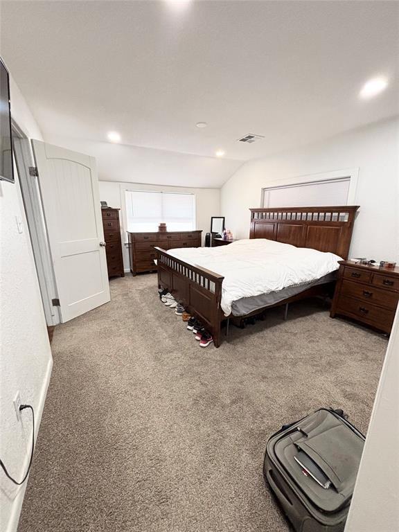 9737 NE State Highway 15, Shattuck, OK 32911 - bedroom featuring visible vents, recessed lighting, carpet flooring, and vaulted ceiling