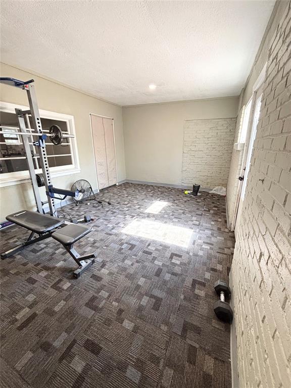 9737 NE State Highway 15, Shattuck, OK 32911 - interior space featuring carpet floors and a textured ceiling