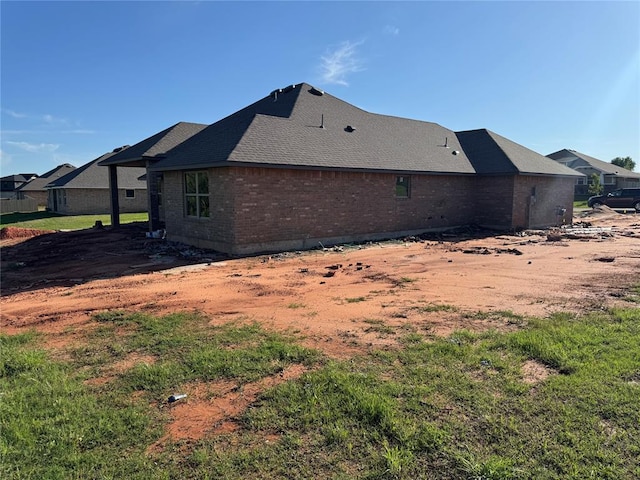 rear view of property featuring brick siding