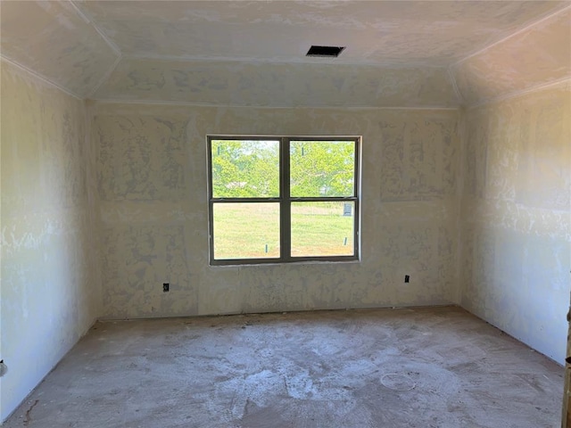 unfurnished room with visible vents and lofted ceiling