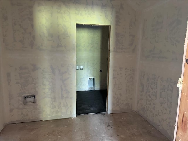 unfurnished room with concrete flooring