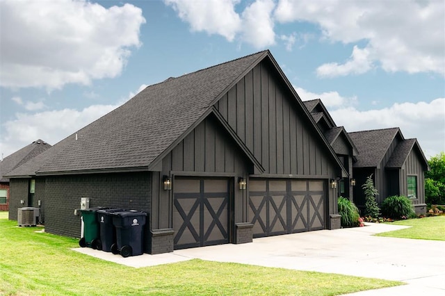 11813 NW 108th Pl, Yukon, OK 73099 - view of front facade with board and batten siding, central AC unit, a front yard, and a shingled roof