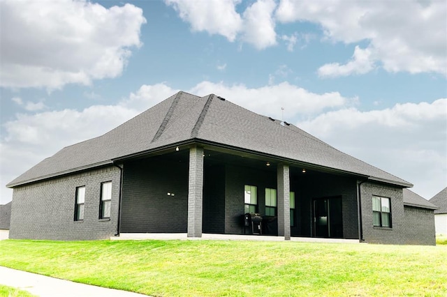11813 NW 108th Pl, Yukon, OK 73099 - rear view of house featuring brick siding, a lawn, and a shingled roof