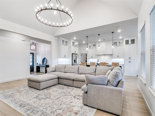 11813 NW 108th Pl, Yukon, OK 73099 - living area featuring high vaulted ceiling, recessed lighting, baseboards, a chandelier, and light wood finished floors