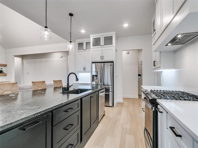 11813 NW 108th Pl, Yukon, OK 73099 - kitchen featuring a sink, premium range hood, stainless steel appliances, white cabinets, and light wood-style floors