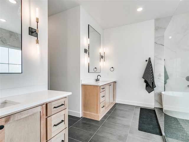 11813 NW 108th Pl, Yukon, OK 73099 - bathroom featuring two vanities, a soaking tub, recessed lighting, tile patterned flooring, and baseboards