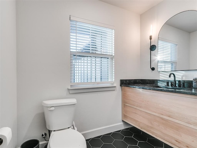 11813 NW 108th Pl, Yukon, OK 73099 - half bath featuring toilet, vanity, tile patterned flooring, and baseboards