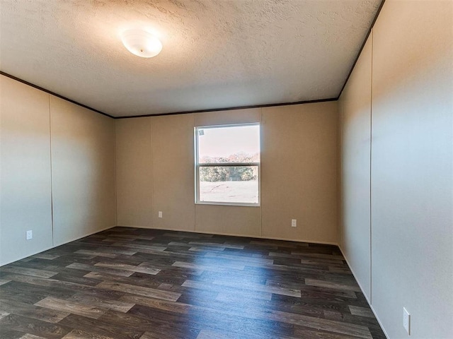 empty room with dark wood-style flooring, crown molding, and a textured ceiling