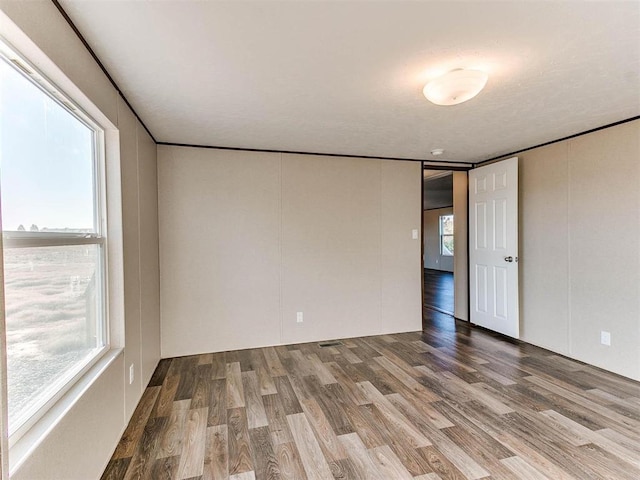 spare room featuring wood finished floors