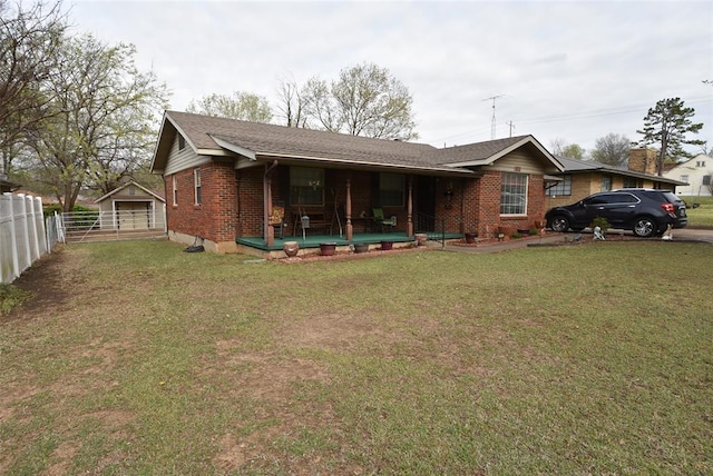 ranch-style home with fence, a front lawn, and brick siding