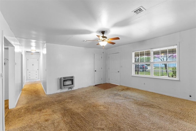 120 E 6th St, Stratford, OK 74872 - unfurnished living room with carpet floors, heating unit, visible vents, and ceiling fan