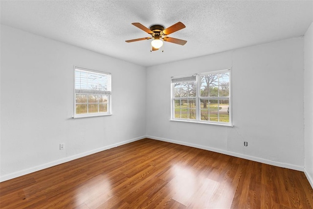 120 E 6th St, Stratford, OK 74872 - unfurnished room featuring baseboards, a textured ceiling, ceiling fan, and wood finished floors