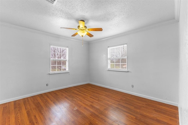 120 E 6th St, Stratford, OK 74872 - spare room featuring crown molding, wood finished floors, a ceiling fan, and plenty of natural light