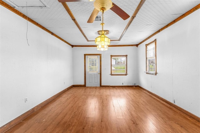 120 E 6th St, Stratford, OK 74872 - empty room featuring attic access, ornamental molding, baseboards, hardwood / wood-style flooring, and visible vents