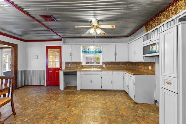 120 E 6th St, Stratford, OK 74872 - kitchen with plenty of natural light, a sink, white microwave, and a ceiling fan