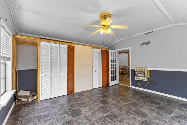 120 E 6th St, Stratford, OK 74872 - unfurnished bedroom with multiple closets, visible vents, ceiling fan, lofted ceiling, and heating unit