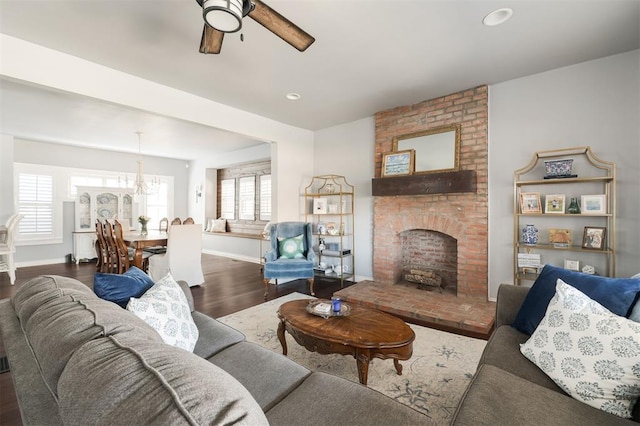 1412 NW 34th St, Oklahoma City, OK 73118 - living room with baseboards, a brick fireplace, recessed lighting, wood finished floors, and ceiling fan with notable chandelier