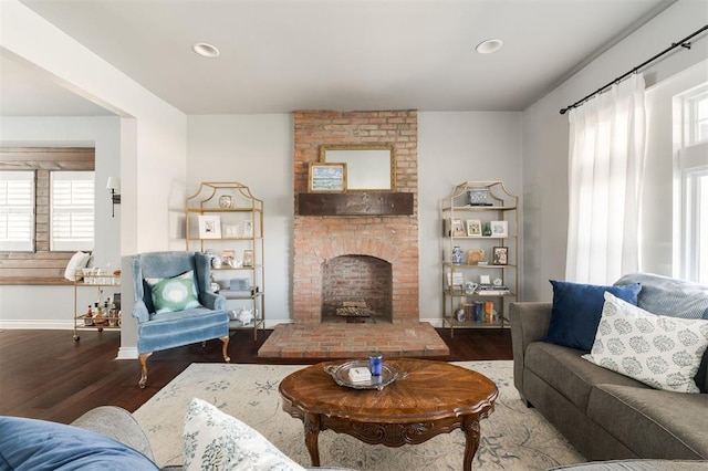1412 NW 34th St, Oklahoma City, OK 73118 - living area featuring a brick fireplace, wood finished floors, and a healthy amount of sunlight