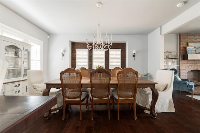 1412 NW 34th St, Oklahoma City, OK 73118 - dining room with a brick fireplace, a notable chandelier, and wood finished floors
