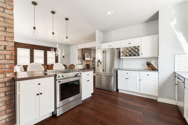 1412 NW 34th St, Oklahoma City, OK 73118 - kitchen with tasteful backsplash, white cabinets, appliances with stainless steel finishes, and dark wood-type flooring