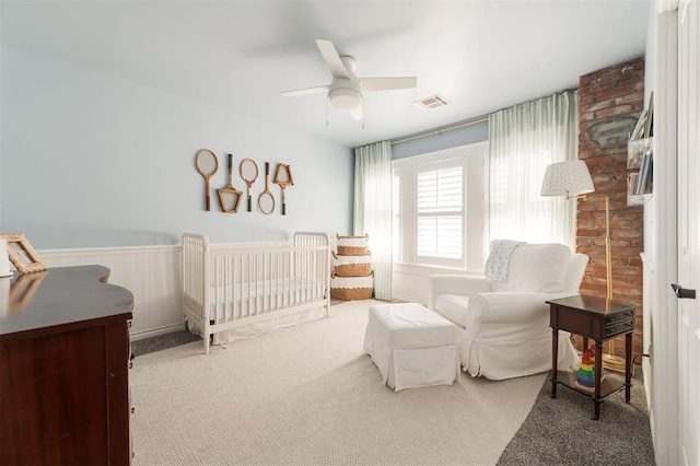 1412 NW 34th St, Oklahoma City, OK 73118 - carpeted bedroom with visible vents, a wainscoted wall, and a ceiling fan