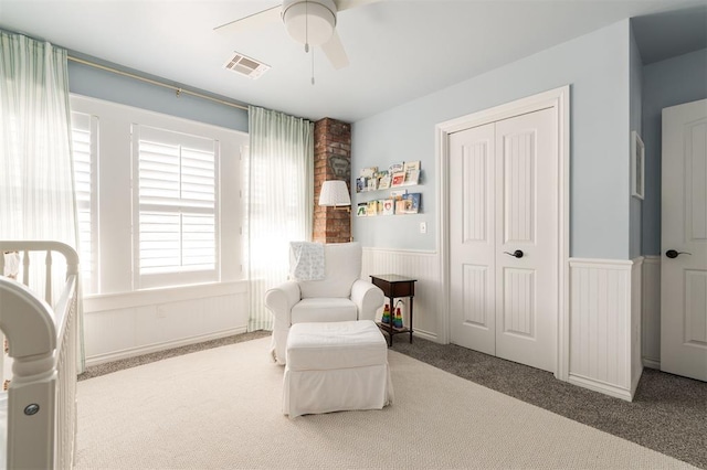 1412 NW 34th St, Oklahoma City, OK 73118 - living area featuring visible vents, a wainscoted wall, a ceiling fan, and carpet