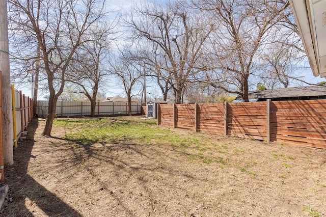 1412 NW 34th St, Oklahoma City, OK 73118 - view of yard with an outbuilding, a fenced backyard, and a storage unit