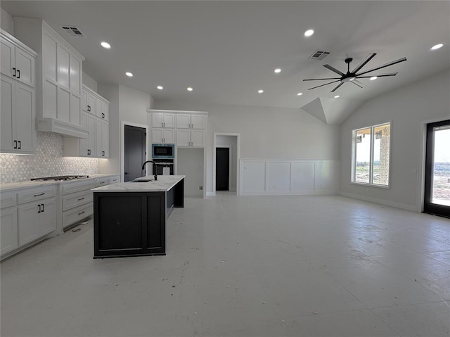 7120 NW 155th St, Edmond, OK 73013 - kitchen featuring decorative backsplash, ceiling fan, visible vents, a center island with sink, and stainless steel appliances