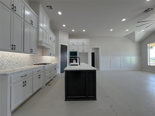 7120 NW 155th St, Edmond, OK 73013 - kitchen featuring a kitchen island with sink, visible vents, tasteful backsplash, a sink, and stainless steel appliances