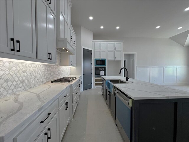 7120 NW 155th St, Edmond, OK 73013 - kitchen with appliances with stainless steel finishes, tasteful backsplash, a large island with sink, a sink, and white cabinets