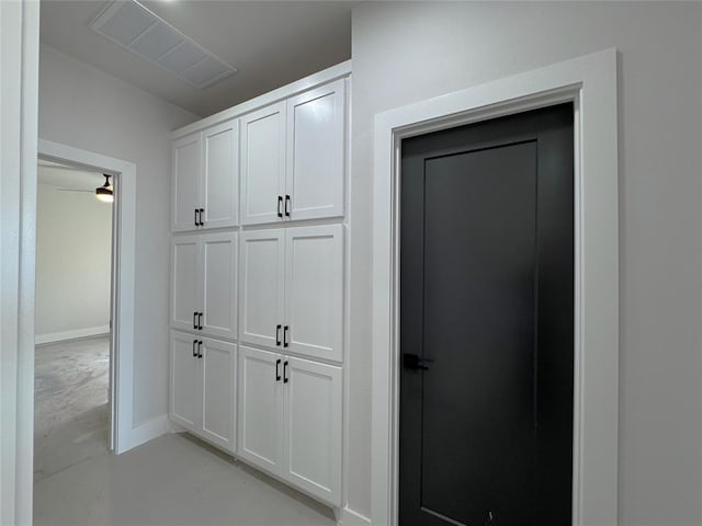 7120 NW 155th St, Edmond, OK 73013 - corridor with baseboards, visible vents, and concrete floors