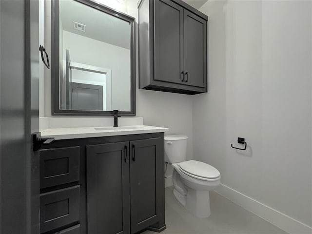 7120 NW 155th St, Edmond, OK 73013 - bathroom with baseboards, visible vents, toilet, and vanity