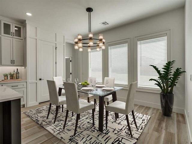 dining room with light wood-style floors, a chandelier, recessed lighting, baseboards, and visible vents