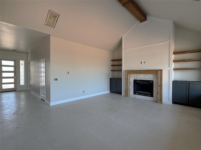 unfurnished living room with visible vents, vaulted ceiling with beams, baseboards, and a premium fireplace
