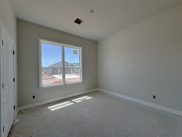 empty room featuring baseboards