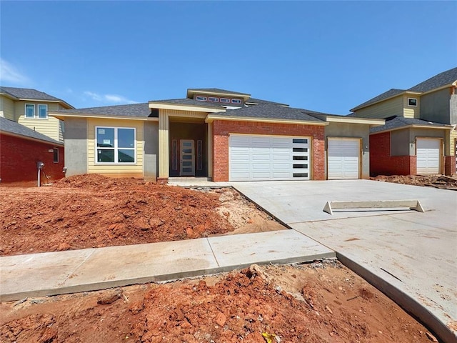 prairie-style home with a garage and concrete driveway