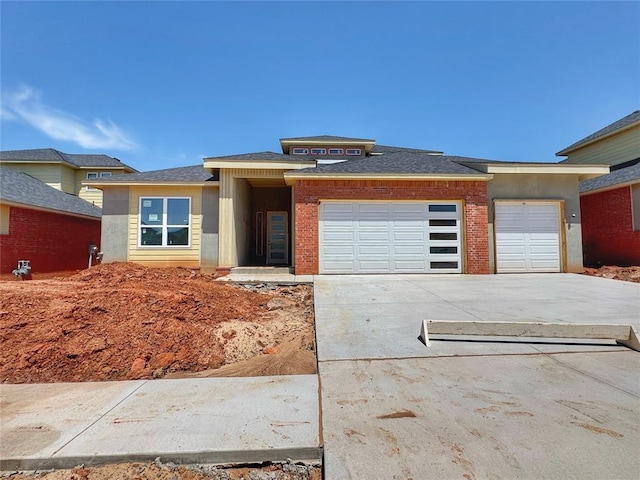 prairie-style house featuring a garage and driveway