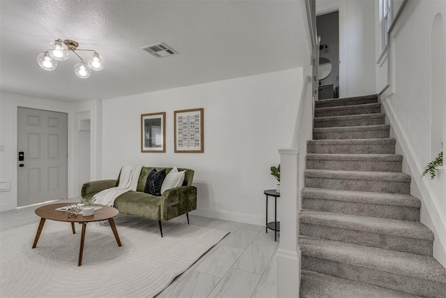 living room with stairway, baseboards, a chandelier, marble finish floor, and visible vents