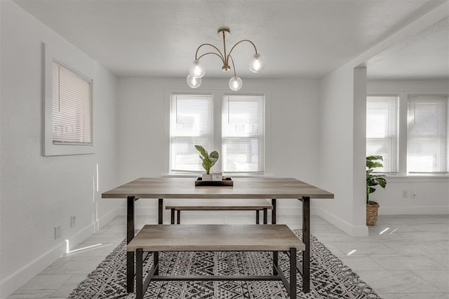 dining room featuring baseboards and marble finish floor
