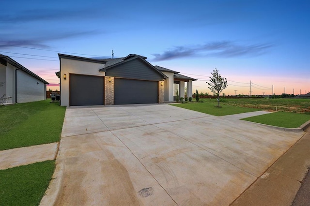 15600 Rockwell Park Ln, Edmond, OK 73013 - view of front of property with a garage, a lawn, concrete driveway, and brick siding