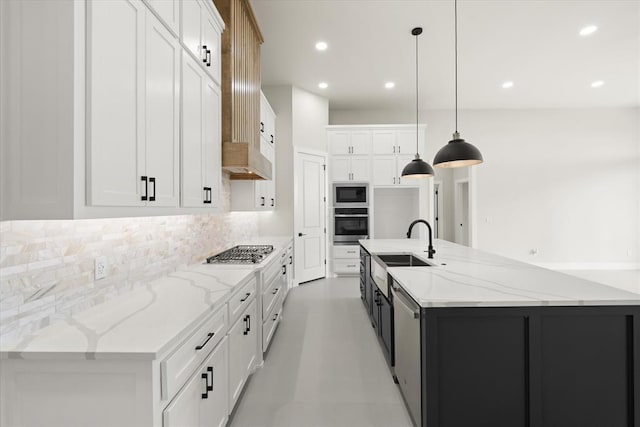 15600 Rockwell Park Ln, Edmond, OK 73013 - kitchen featuring appliances with stainless steel finishes, decorative backsplash, white cabinets, a spacious island, and recessed lighting