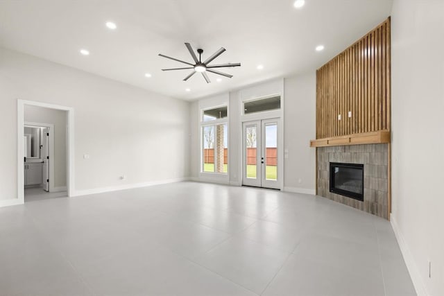 15600 Rockwell Park Ln, Edmond, OK 73013 - unfurnished living room featuring a ceiling fan, a tiled fireplace, and recessed lighting