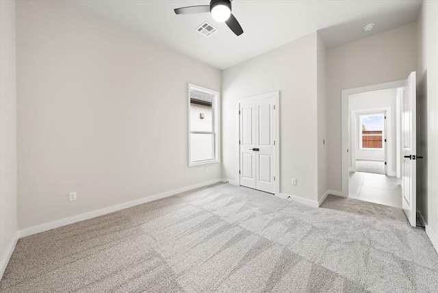 15600 Rockwell Park Ln, Edmond, OK 73013 - unfurnished bedroom with light colored carpet and a ceiling fan