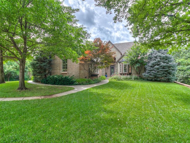 1109 Salvo Bridge Ct, Edmond, OK 73034 - obstructed view of property featuring a front yard and brick siding