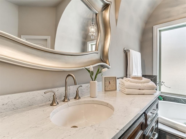 1109 Salvo Bridge Ct, Edmond, OK 73034 - bathroom with vanity, healthy amount of natural light, and a bath