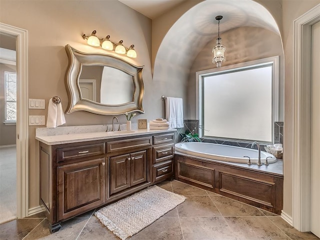 1109 Salvo Bridge Ct, Edmond, OK 73034 - full bath with vanity, a garden tub, and stone finish floors