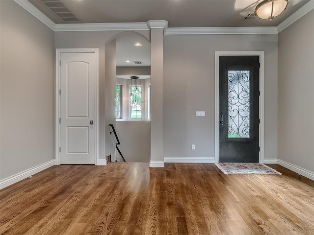 1109 Salvo Bridge Ct, Edmond, OK 73034 - foyer entrance with wood finished floors, ornamental molding, and arched walkways
