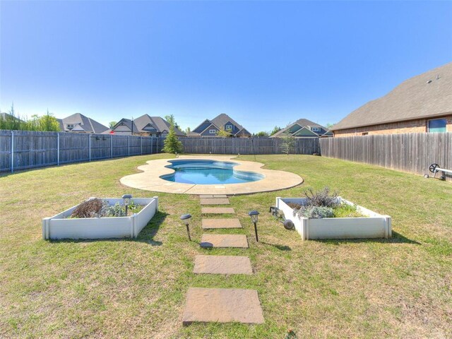 view of pool featuring a fenced backyard, a vegetable garden, a fenced in pool, and a lawn