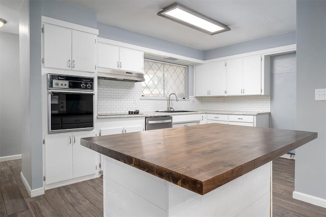 1527 N Pennsylvania Ave, Shawnee, OK 74804 - kitchen with black appliances, under cabinet range hood, dark wood-style flooring, and white cabinets