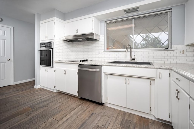1527 N Pennsylvania Ave, Shawnee, OK 74804 - kitchen featuring black appliances, under cabinet range hood, tasteful backsplash, white cabinetry, and dark wood finished floors